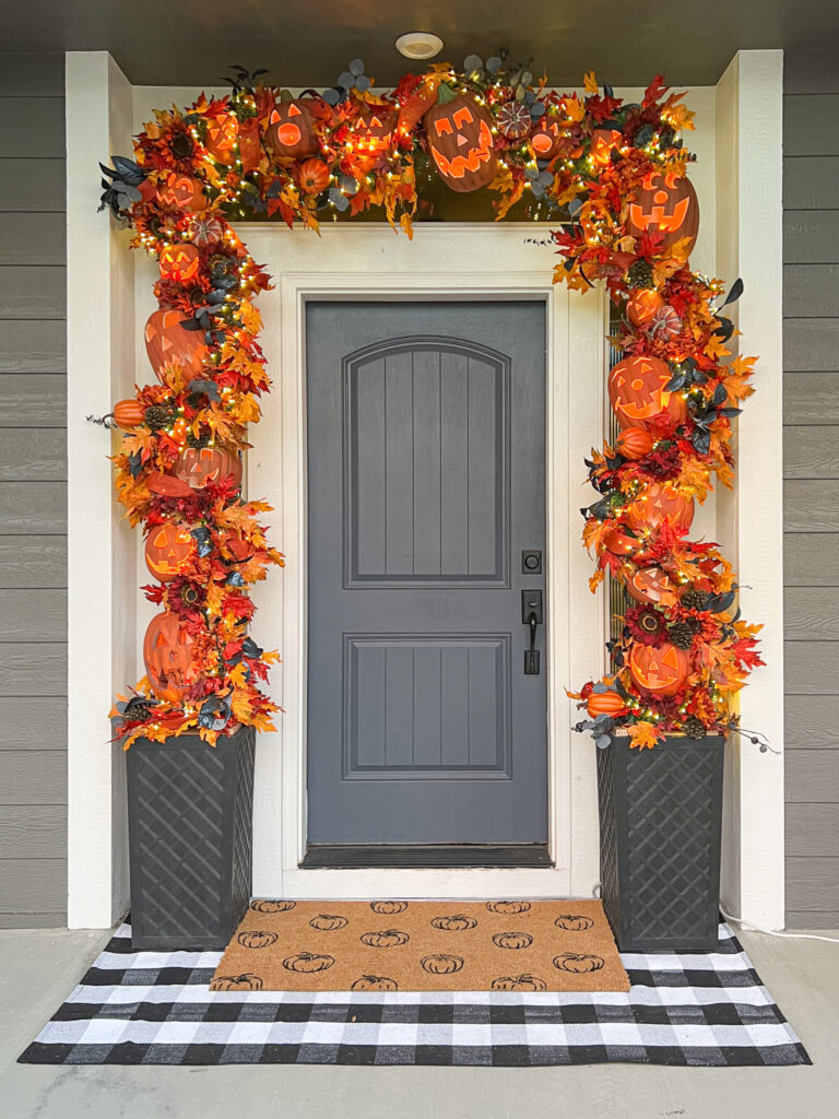 Fall garland with pumpkin door mat and buffalo plaid rug.